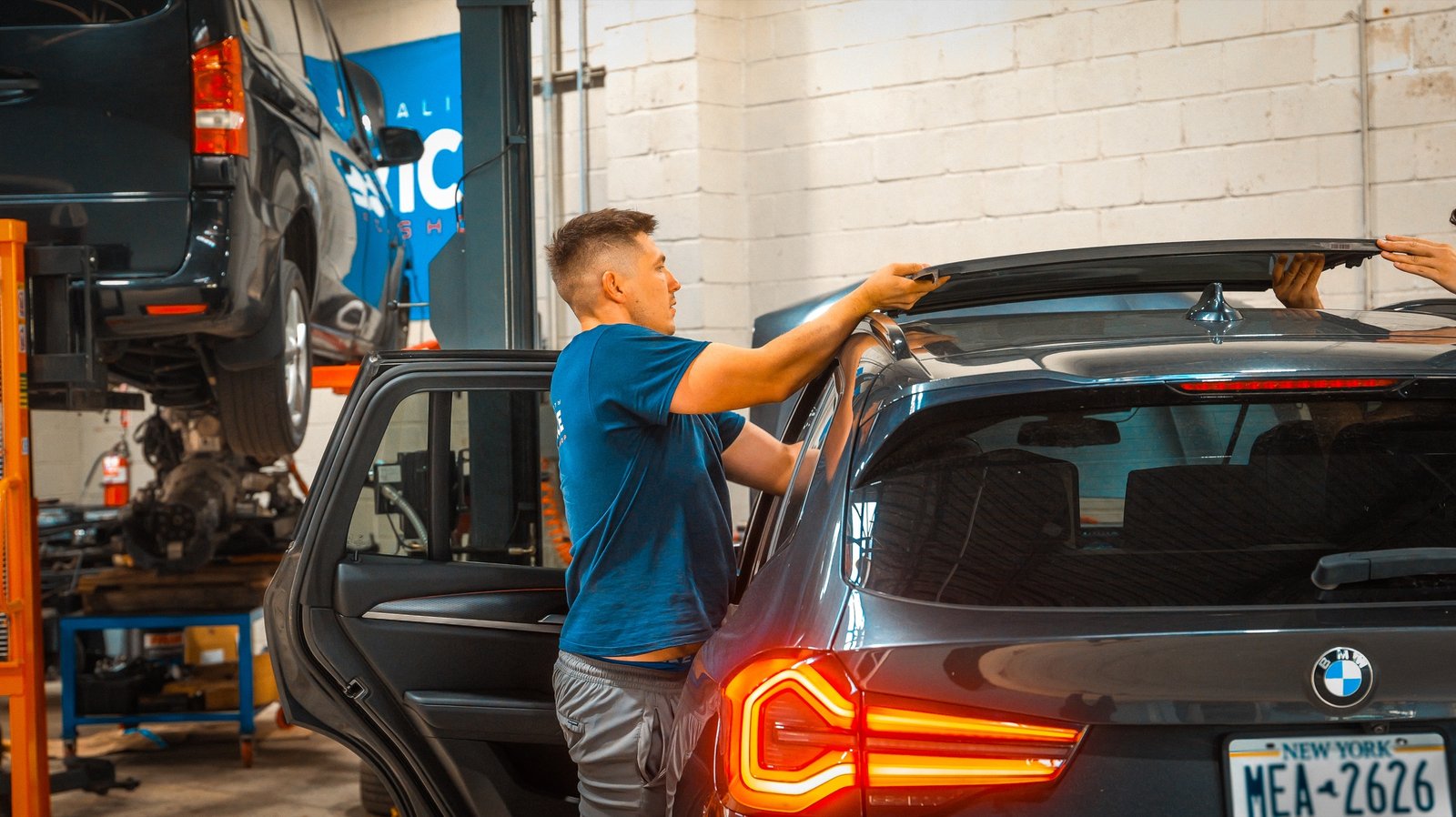 Technician installing a vehicle roof accessory